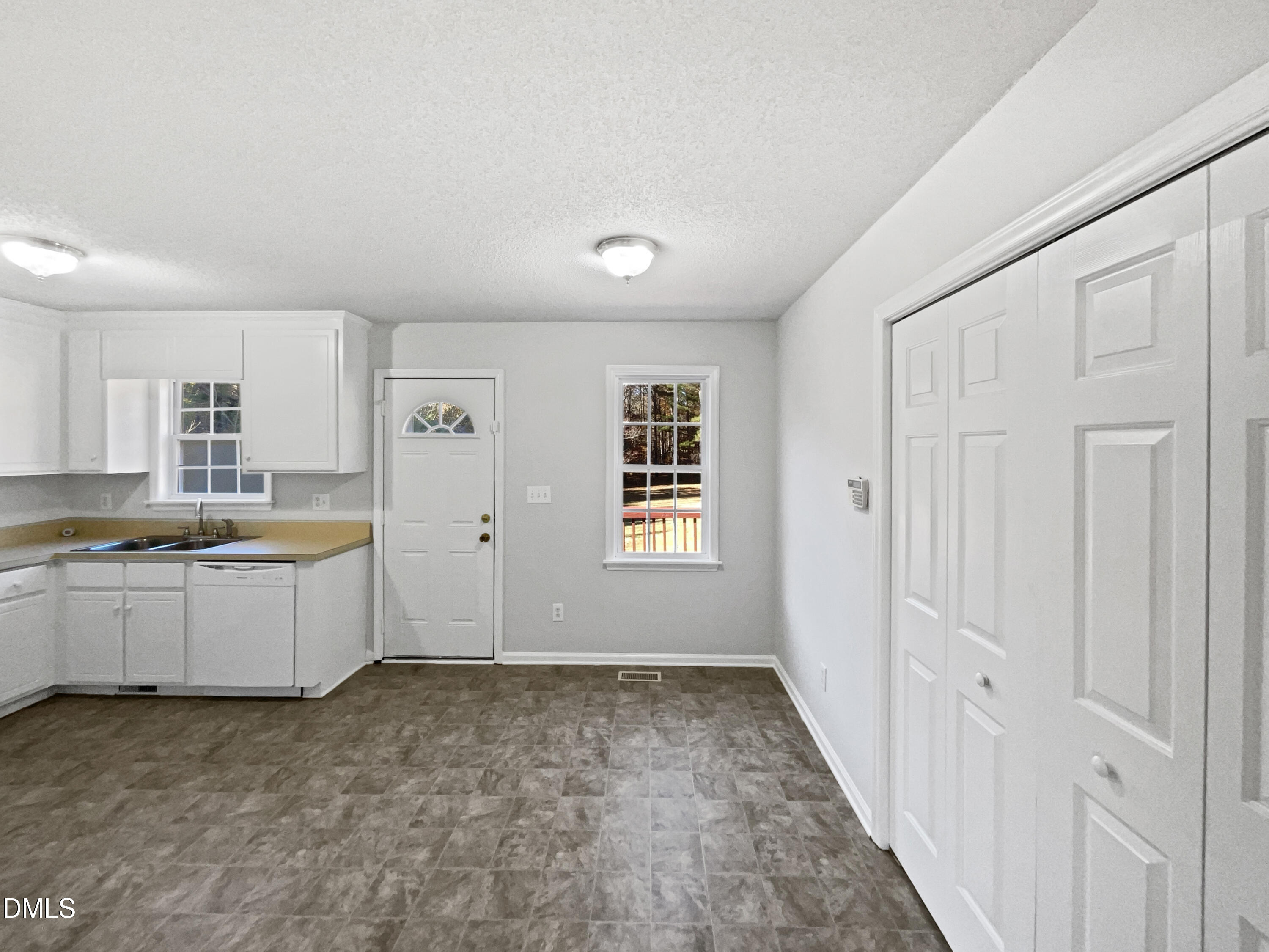 9025 Ferrell Road Zebulon, NC 27597 - Photo 8 of 19 a large white kitchen with a sink