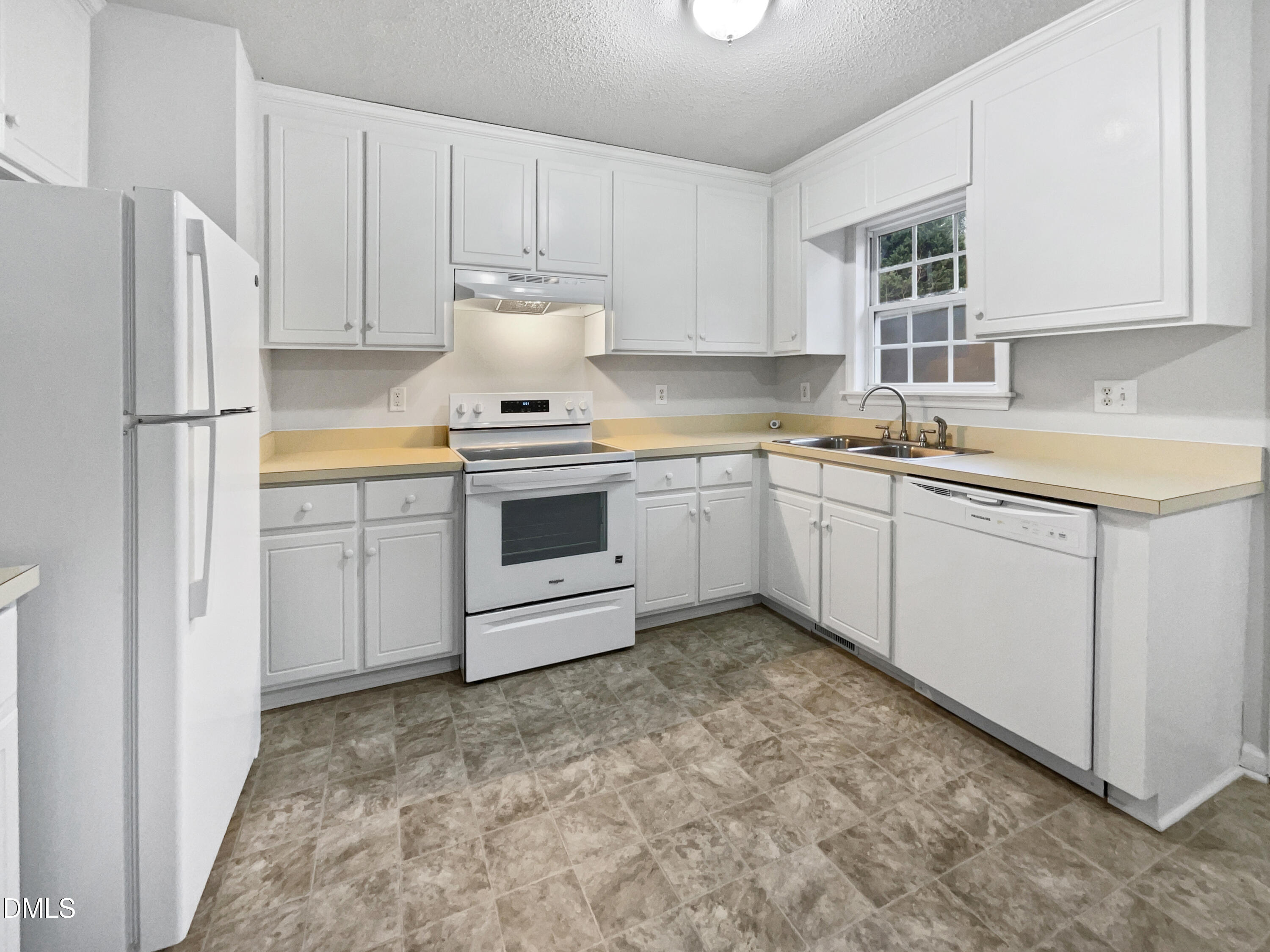 9025 Ferrell Road Zebulon, NC 27597 - Photo 9 of 19 a kitchen with a sink stove and refrigerator