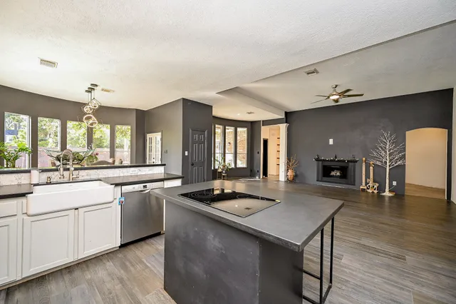 a kitchen with a table chairs sink and cabinets