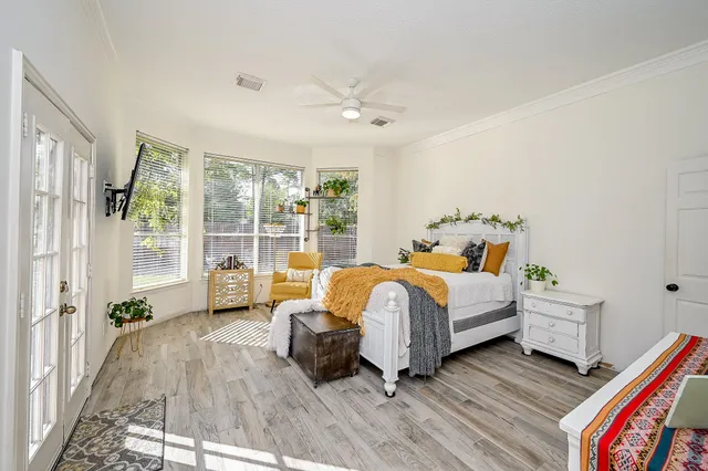 a bedroom with a bed and a large window