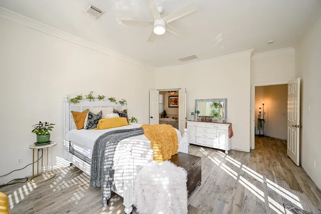 a bedroom with a bed and wooden floor