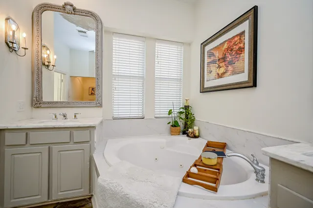a bath room with a bath tub and a sink