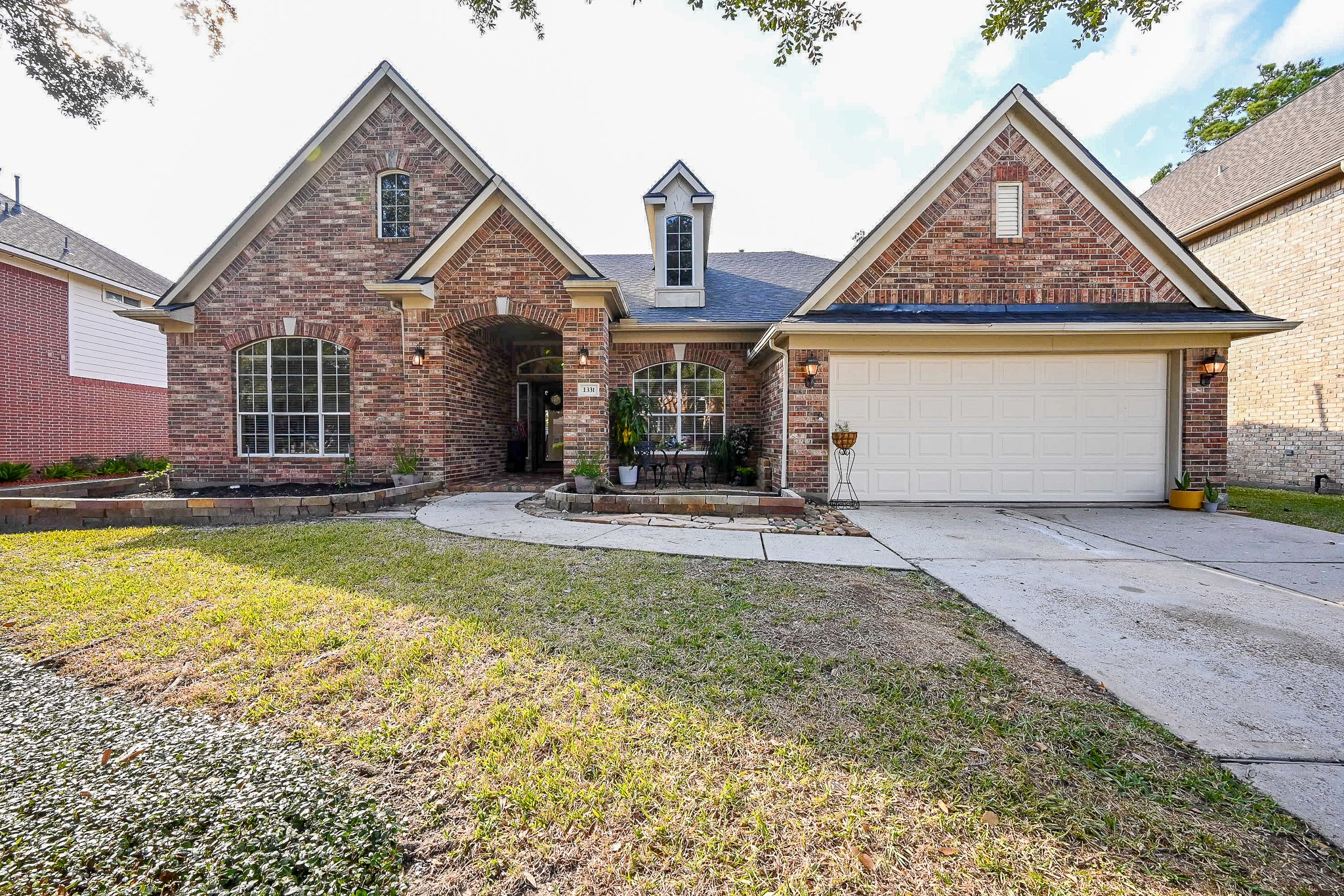 1331 Bishops Pl Drive Spring, TX 77379 - Photo 2 of 31 a front view of a house with a yard and garage