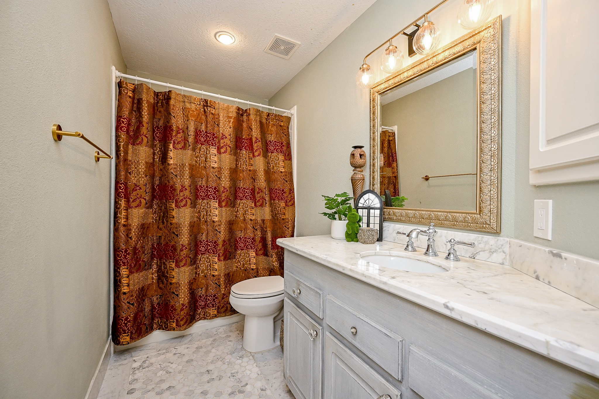1331 Bishops Pl Drive Spring, TX 77379 - Photo 24 of 31 a bathroom with a granite countertop sink a toilet and shower