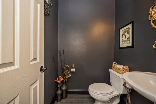 a white toilet sitting next to a bathroom sink