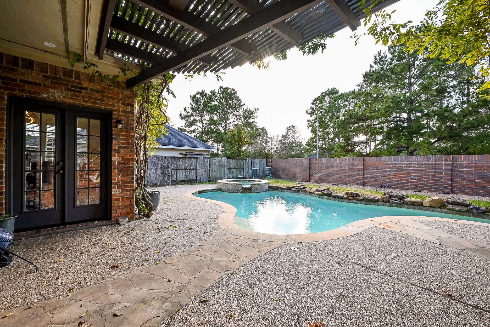 1331 Bishops Pl Drive Spring, TX 77379 - Photo 29 of 31 a view of a backyard with swimming pool and sitting area