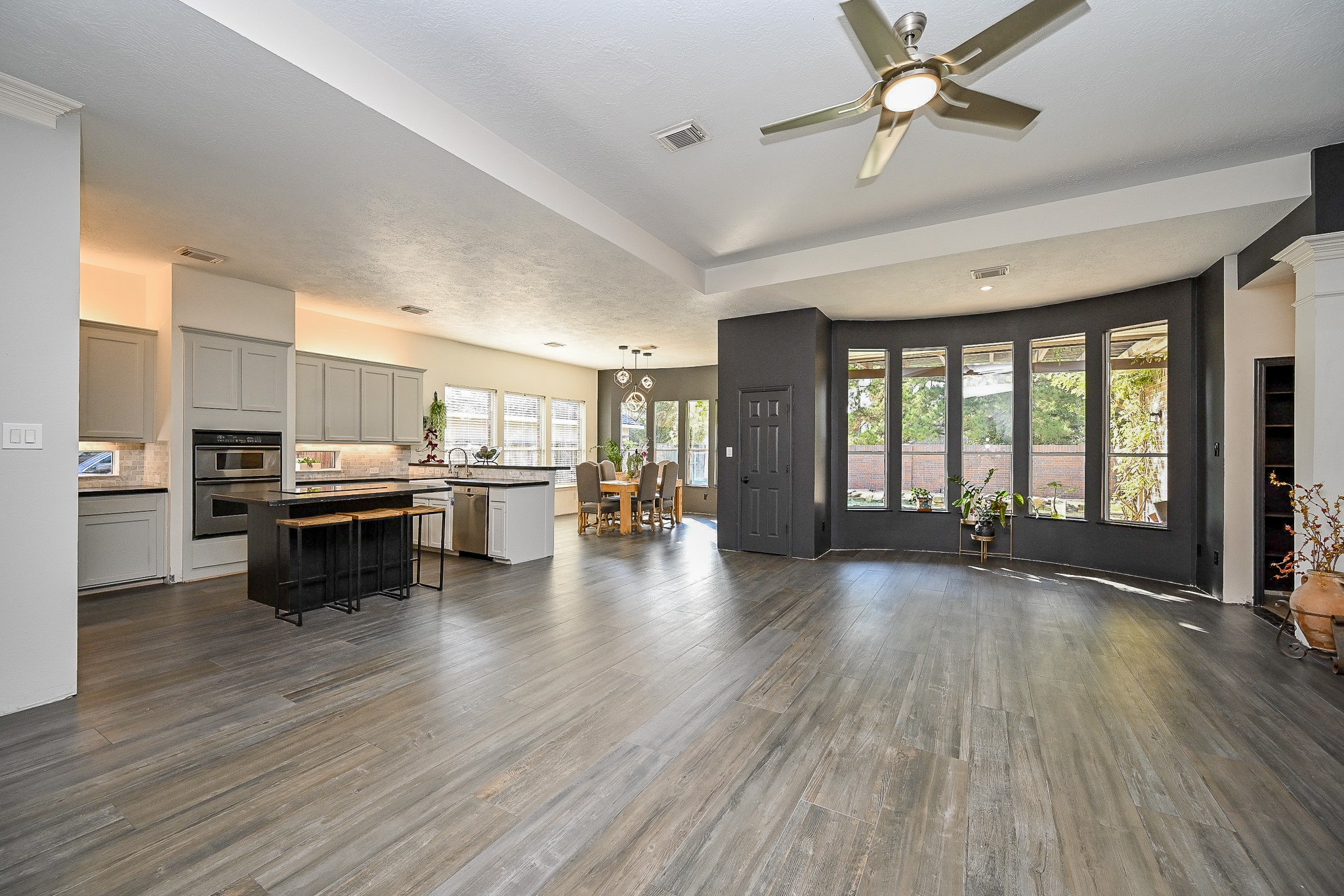 1331 Bishops Pl Drive Spring, TX 77379 - Photo 7 of 31 a open kitchen with kitchen island wooden floors and stainless steel appliances