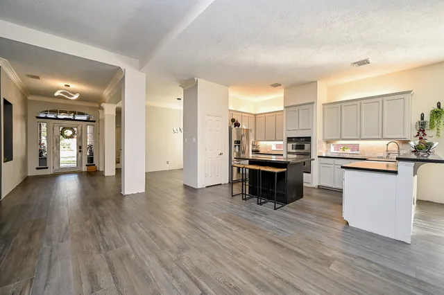 a kitchen with a refrigerator and a stove top oven