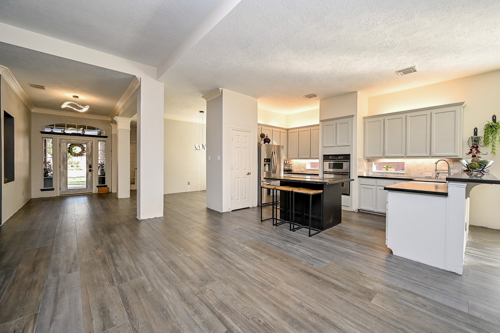 1331 Bishops Pl Drive Spring, TX 77379 - Photo 9 of 31 a kitchen with a refrigerator and a stove top oven