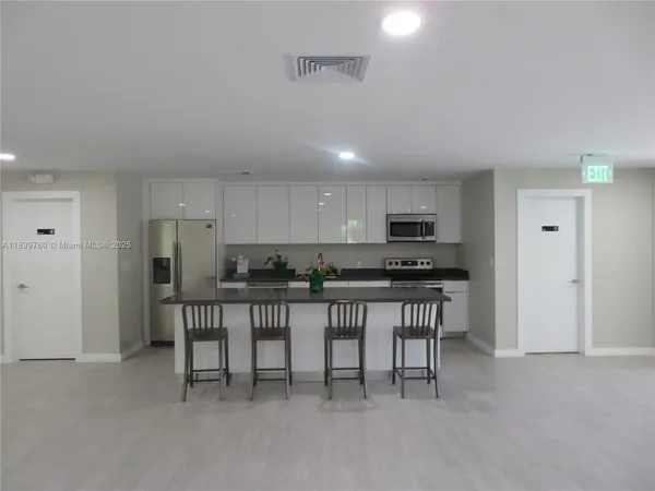 a kitchen with a table and chairs in it