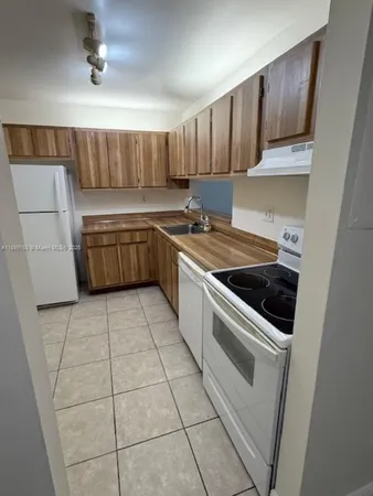 a kitchen with a sink appliances and cabinets