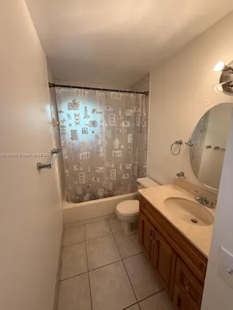 a bathroom with a granite countertop sink a toilet and shower