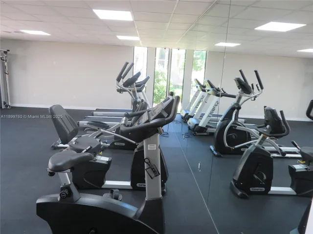 a view of a room with gym equipment and a large window