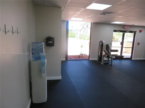 a view of a room with gym equipment and a large window