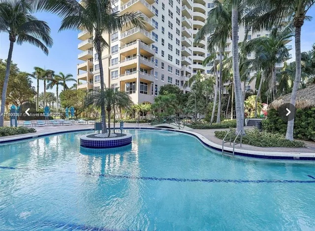 a view of a swimming pool with lounge chairs