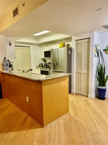 a kitchen with stainless steel appliances a stove a refrigerator and cabinets