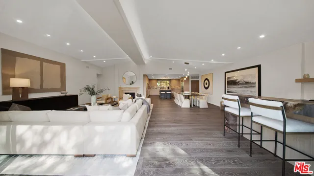 a bedroom with a bed and a mirror on the dresser