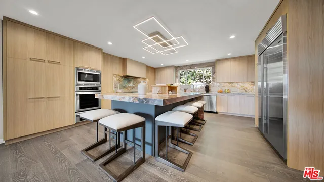 a bathroom with a granite countertop sink mirror vanity bathtub and a toilet
