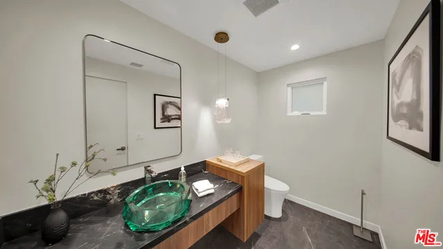 a bathroom with a granite countertop sink mirror bathtub and shower