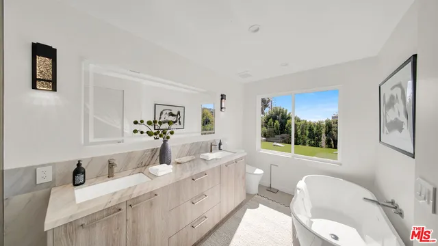 a large white kitchen with a large window