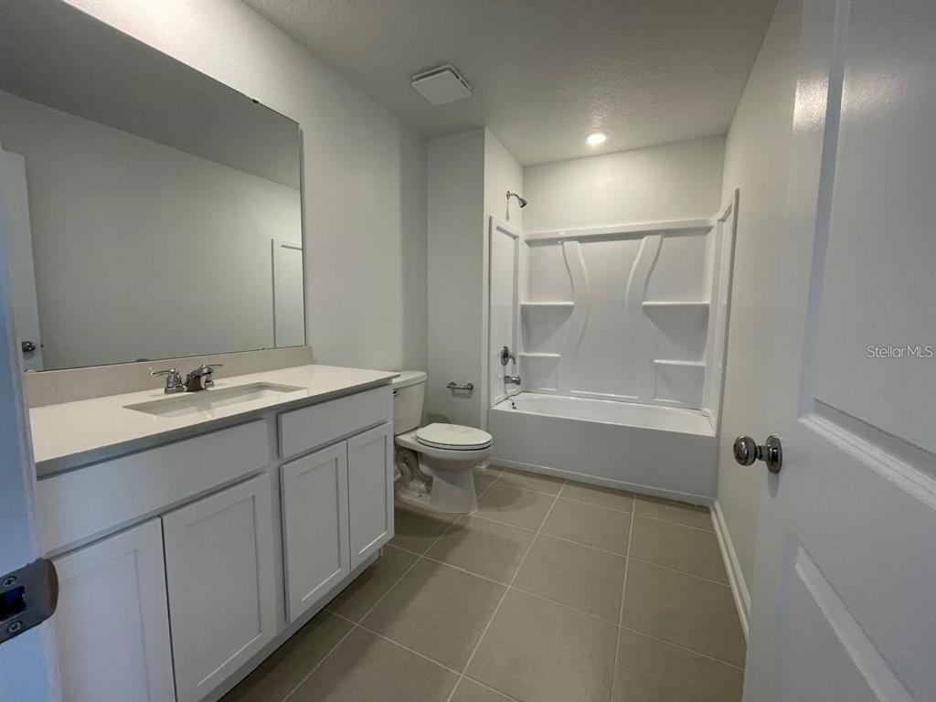 3675 Hardman Dr Lake Lake Wales, FL 33853 - Photo 5 of 11 a bathroom with a double vanity sink toilet and shower
