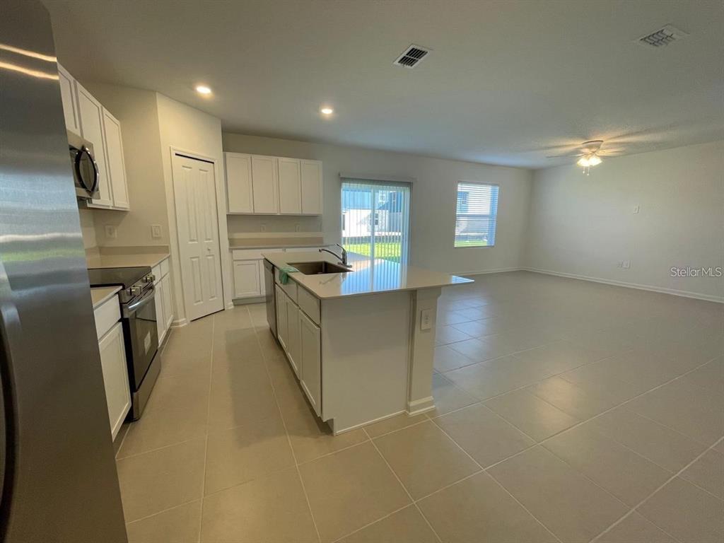 3675 Hardman Dr Lake Lake Wales, FL 33853 - Photo 7 of 11 a view of a kitchen with refrigerator and windows