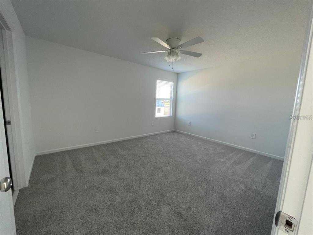3675 Hardman Dr Lake Lake Wales, FL 33853 - Photo 8 of 11 an empty room that has a chandelier fan and a window