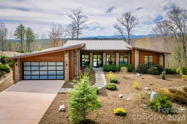a view of a house with wooden floor in front of it