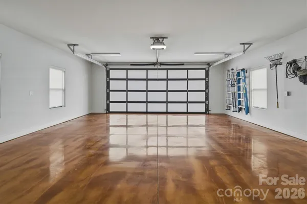 a bathroom with a granite countertop sink mirror and shower