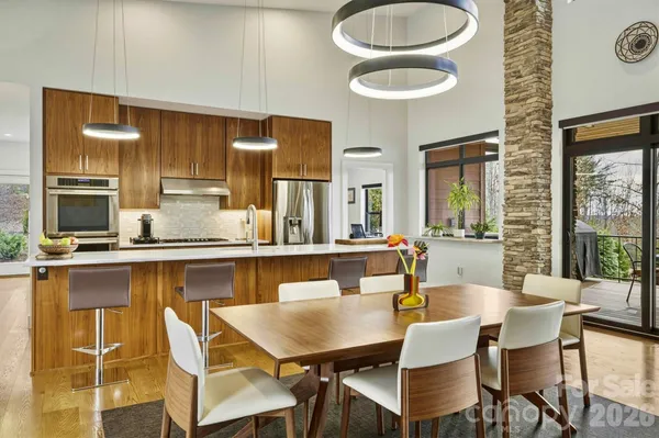 a view of a patio with table and chairs and potted plants