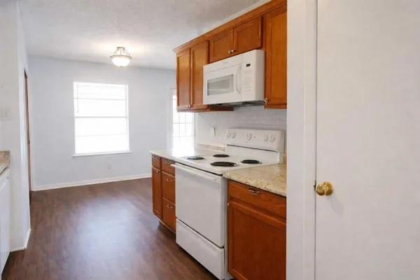 a kitchen with a stove and a microwave