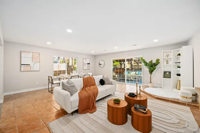 a living room with furniture and a potted plant
