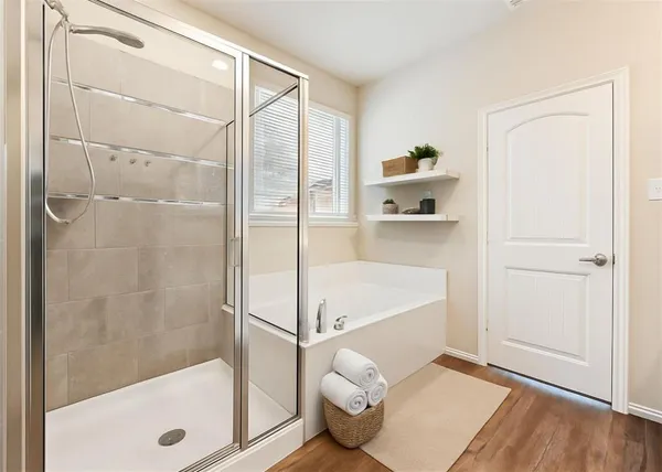 a bathroom with a tub and shower