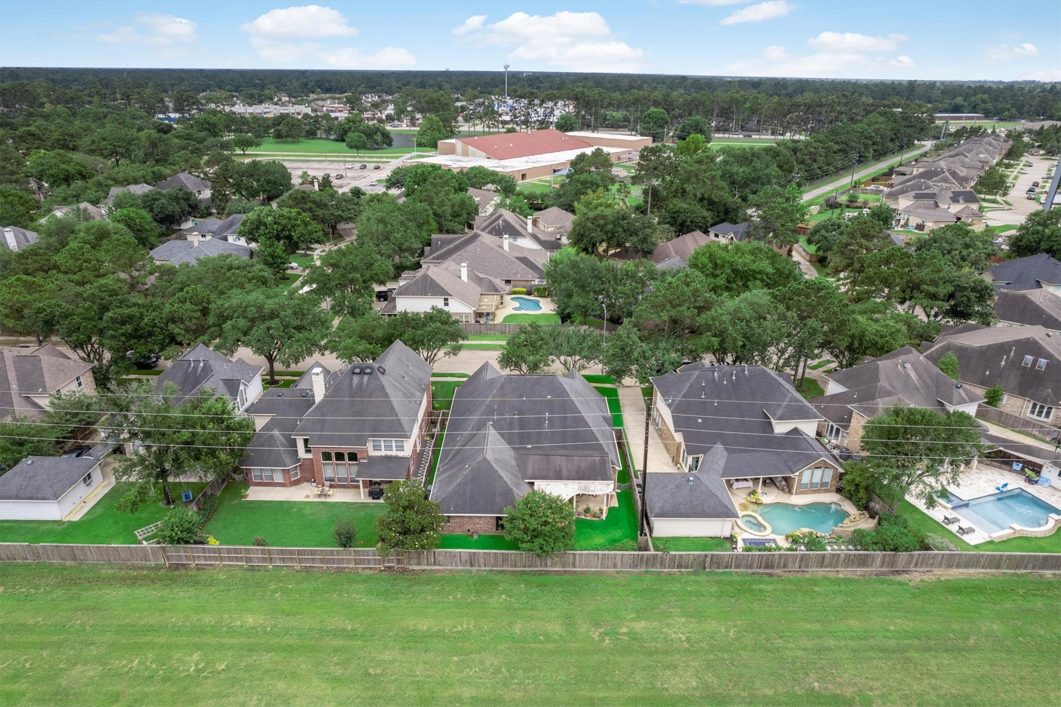 9406 Lochflora Drive Spring, TX 77379 - Photo 39 of 49 an aerial view of residential houses with outdoor space and trees
