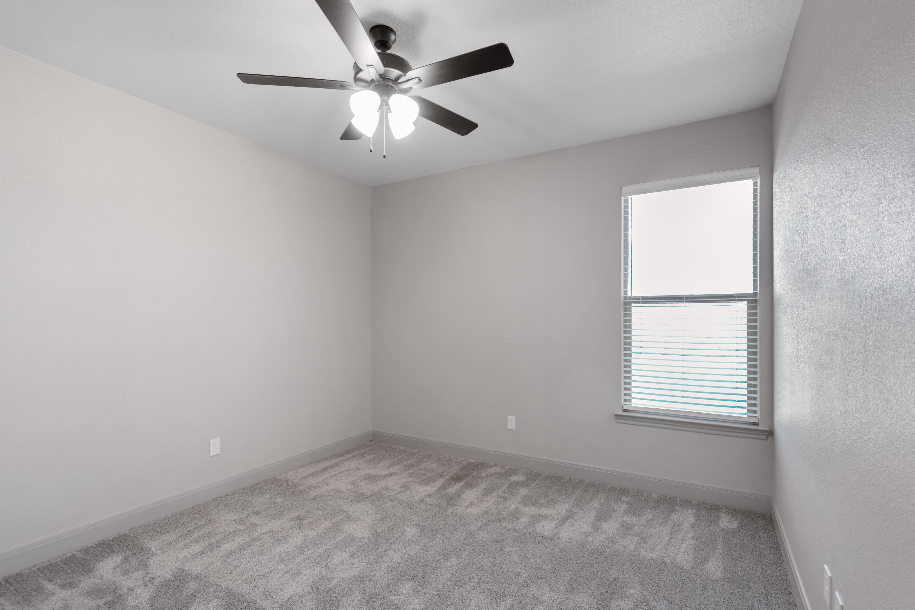 2802 134th Street Lubbock, TX 79423 - Photo 14 of 27 an empty room with a window and a fan