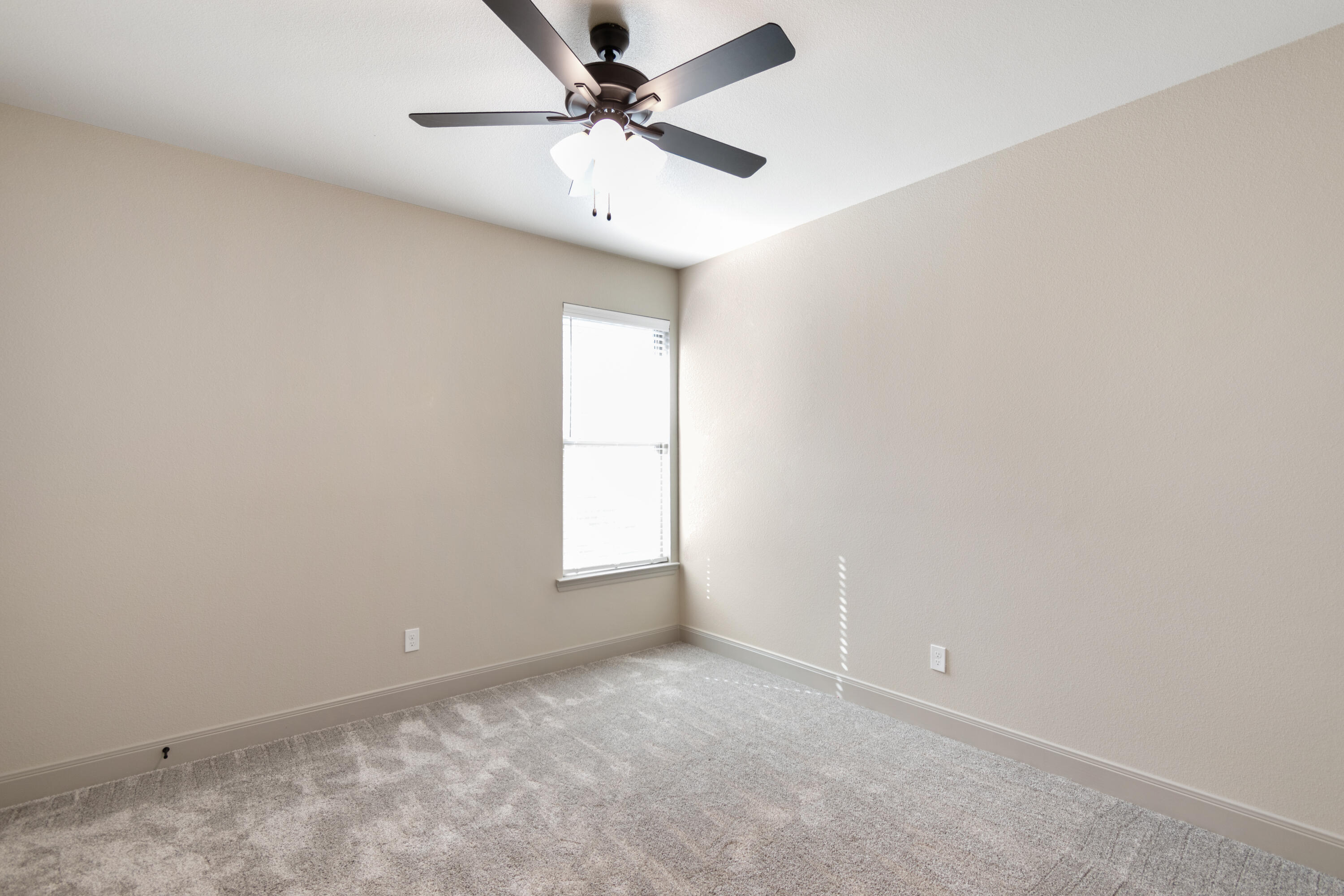 2802 134th Street Lubbock, TX 79423 - Photo 18 of 27 an empty room with a window and a fan