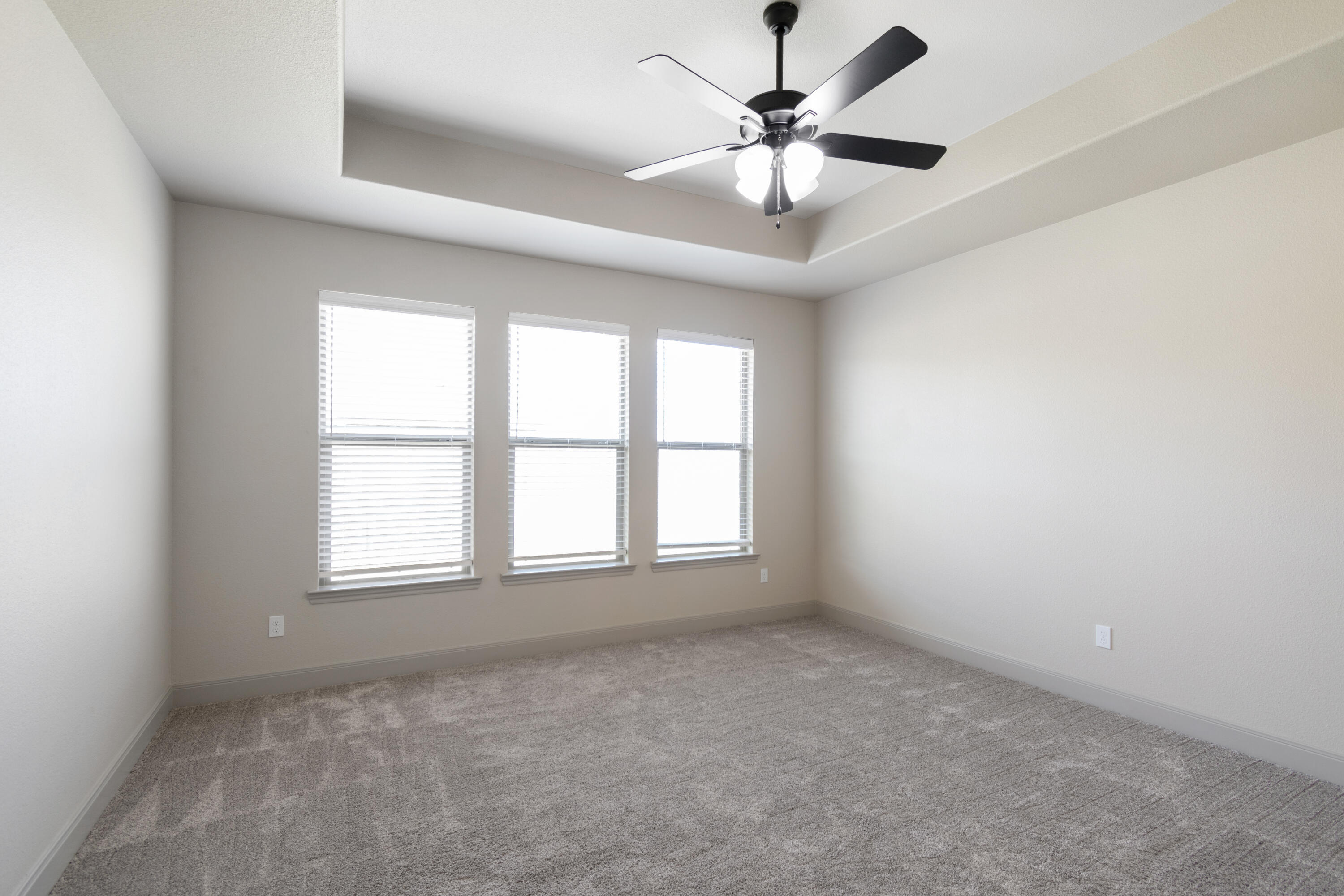 2802 134th Street Lubbock, TX 79423 - Photo 20 of 27 an empty room with a chandelier fan and windows