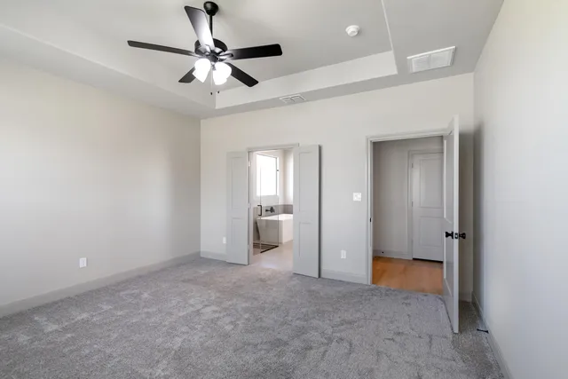 wooden floor in an empty room and a bathroom