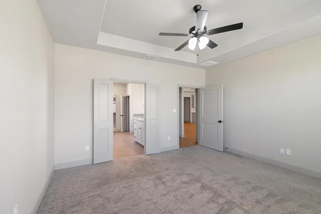 a view of a room with a ceiling fan