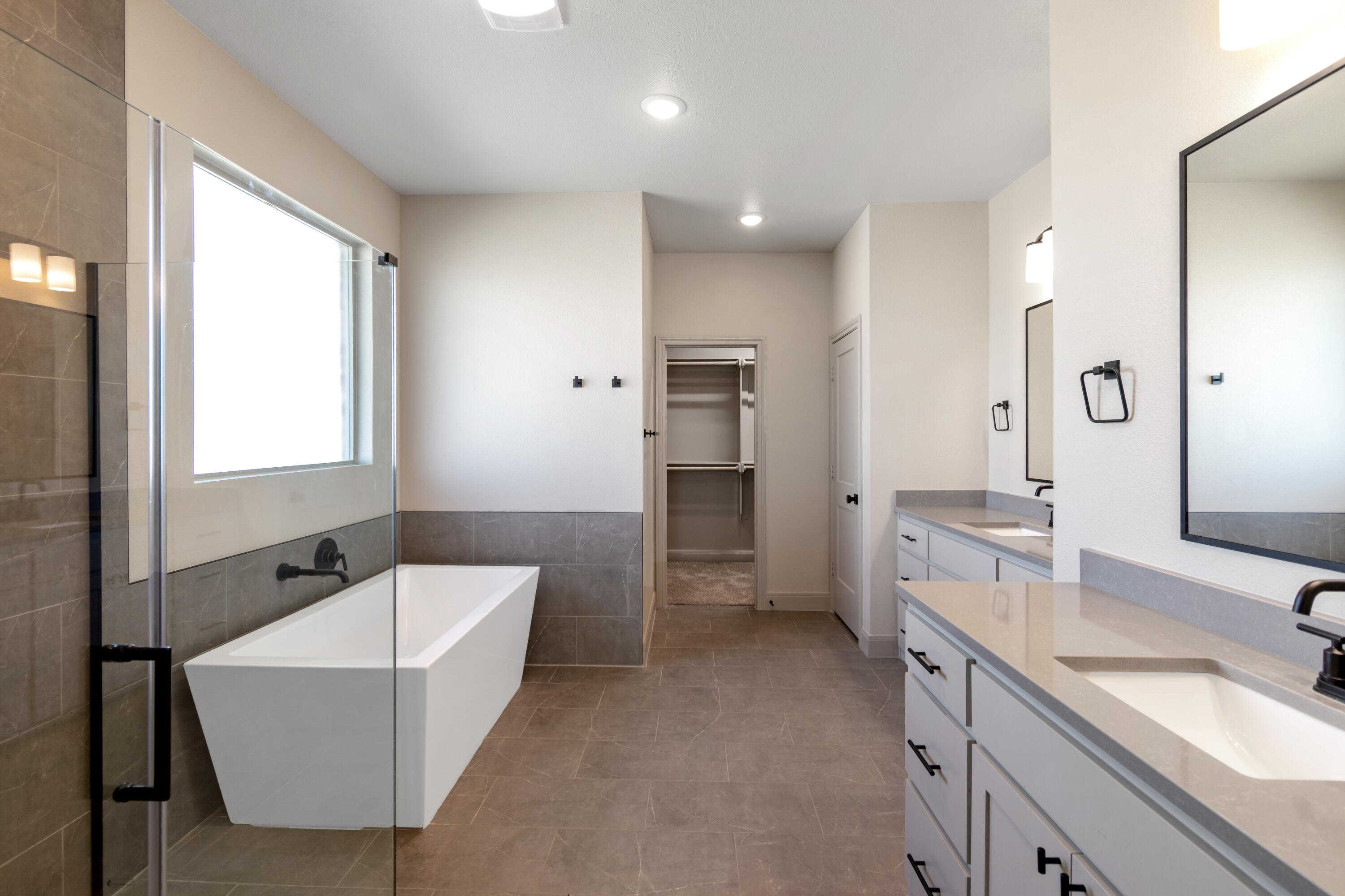 2802 134th Street Lubbock, TX 79423 - Photo 23 of 27 a bathroom with a tub sink double vanity granite tub shower and mirror