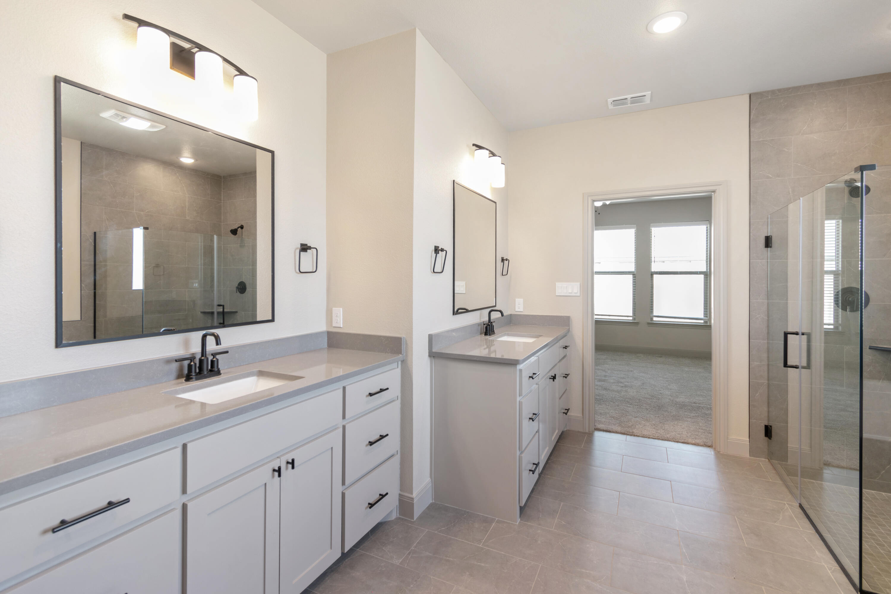 2802 134th Street Lubbock, TX 79423 - Photo 25 of 27 a spacious bathroom with double sink and a mirror