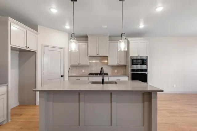 a kitchen with kitchen island white cabinets and refrigerator