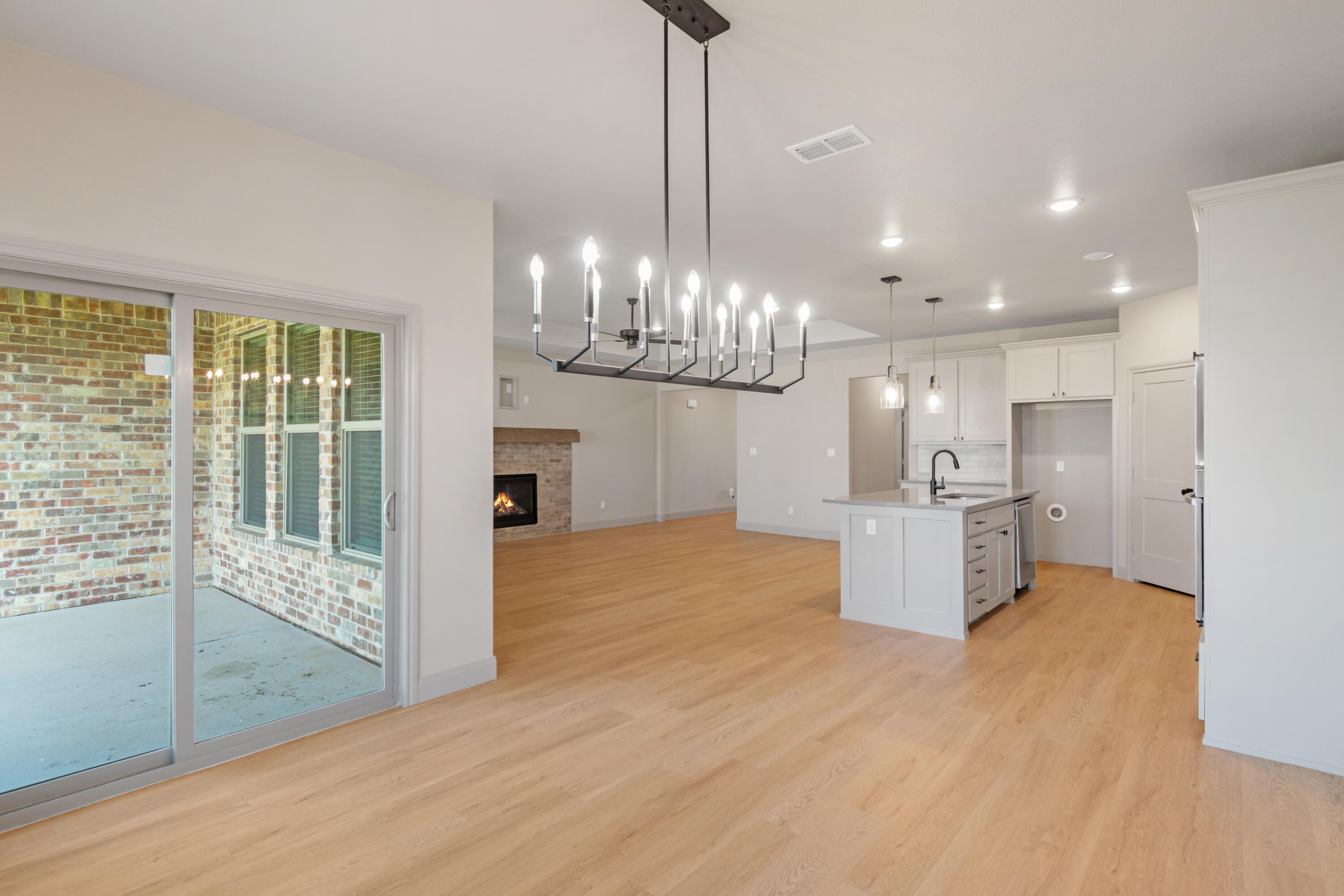 2802 134th Street Lubbock, TX 79423 - Photo 8 of 27 a view of a room with wooden floor and large windows