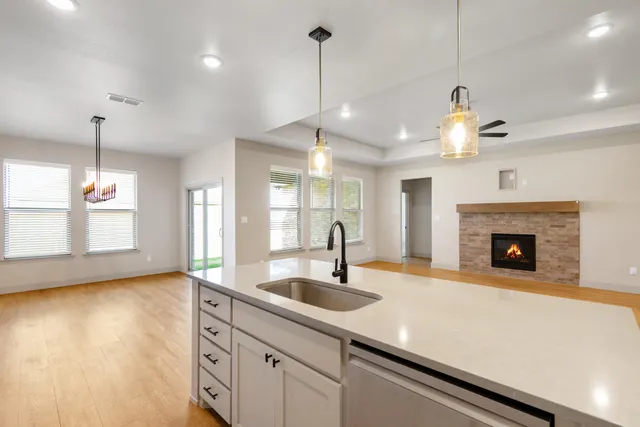 a kitchen with a sink and chandelier