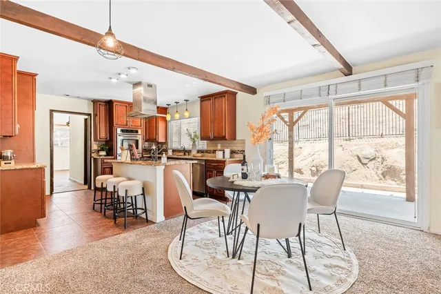 a dining room with furniture a chandelier and wooden floor