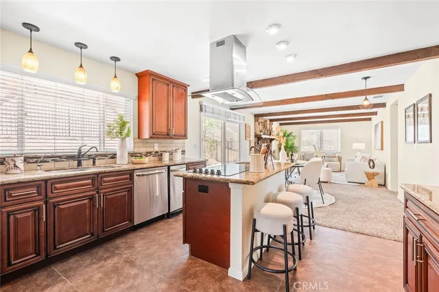 a large kitchen with lots of counter top space and dining table