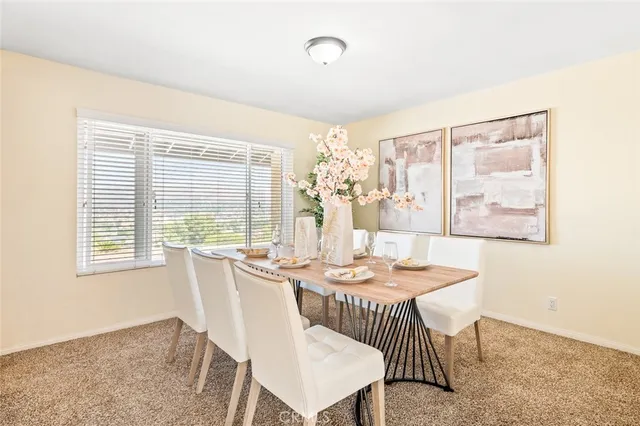 a dining room with furniture and window