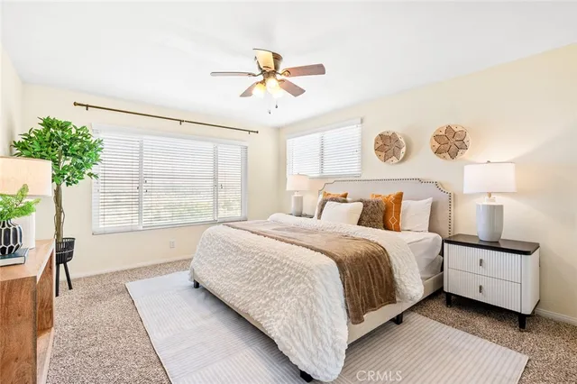 a bedroom with a large bed and a window