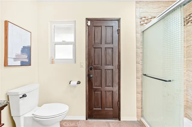a white toilet sitting next to a bathroom sink