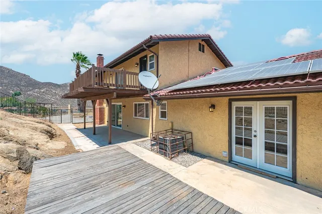 a front view of a house with a yard and balcony